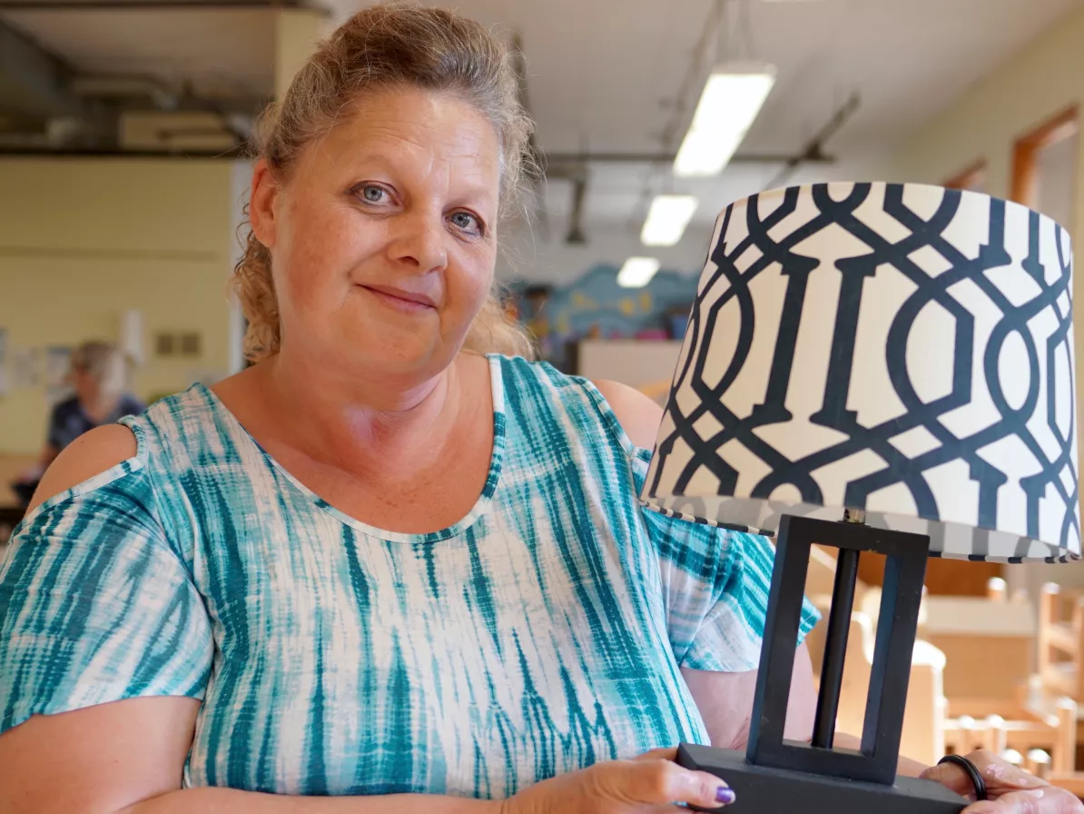 A woman holding a lamp