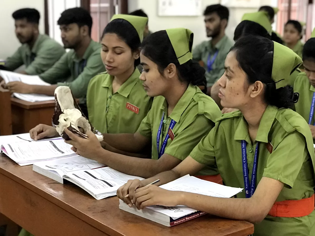 Nursing students examining a bone in a classroom