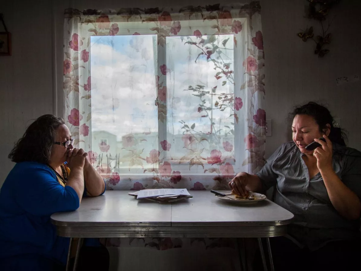 Two women sitting at a kitchen table