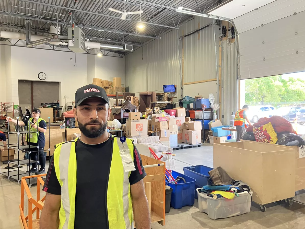 A man standing in a thrift warehouse