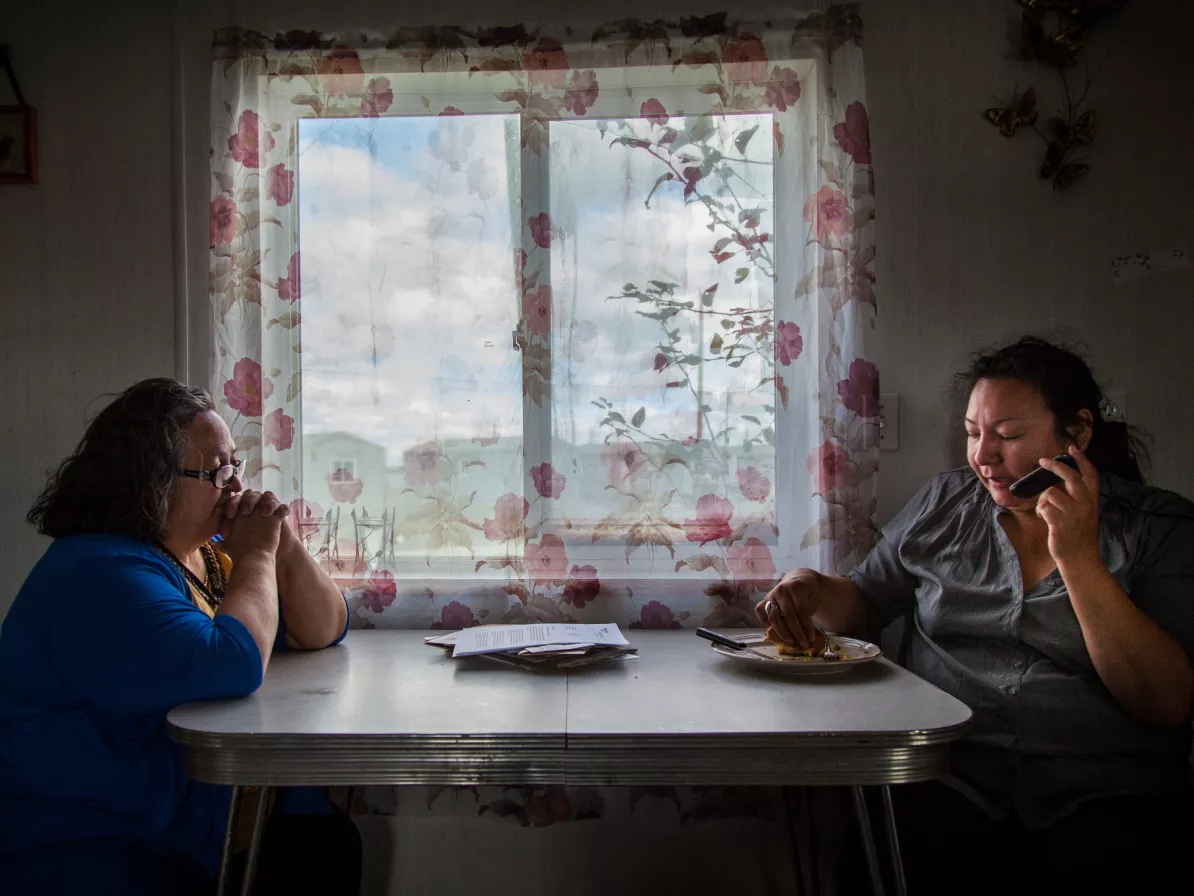 two people sitting beside table