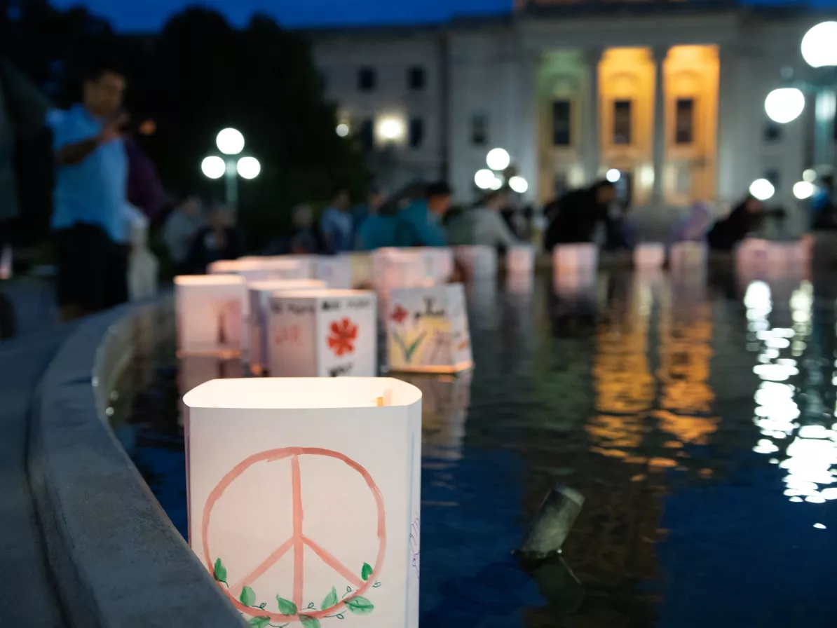 lantern floating on water with peace symbol