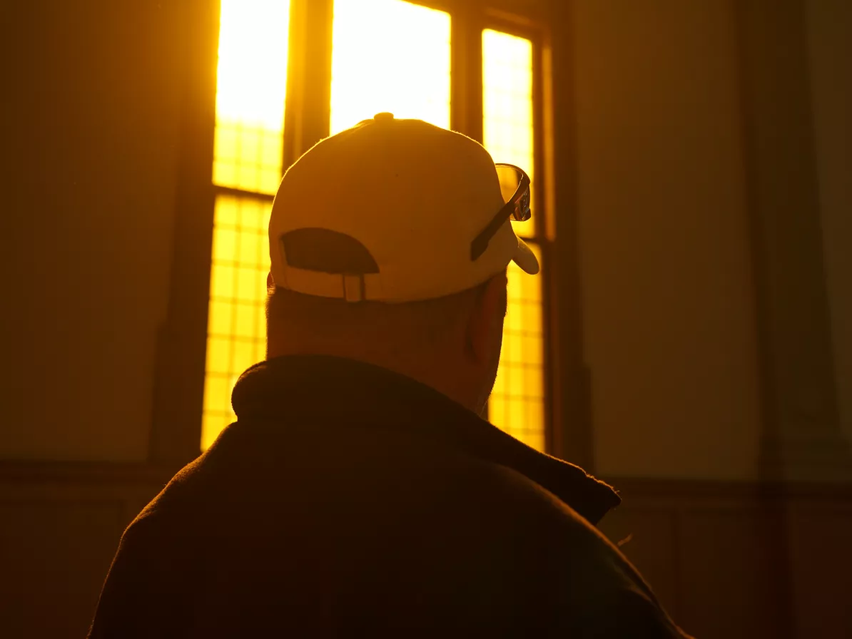 profile of man sitting beside window