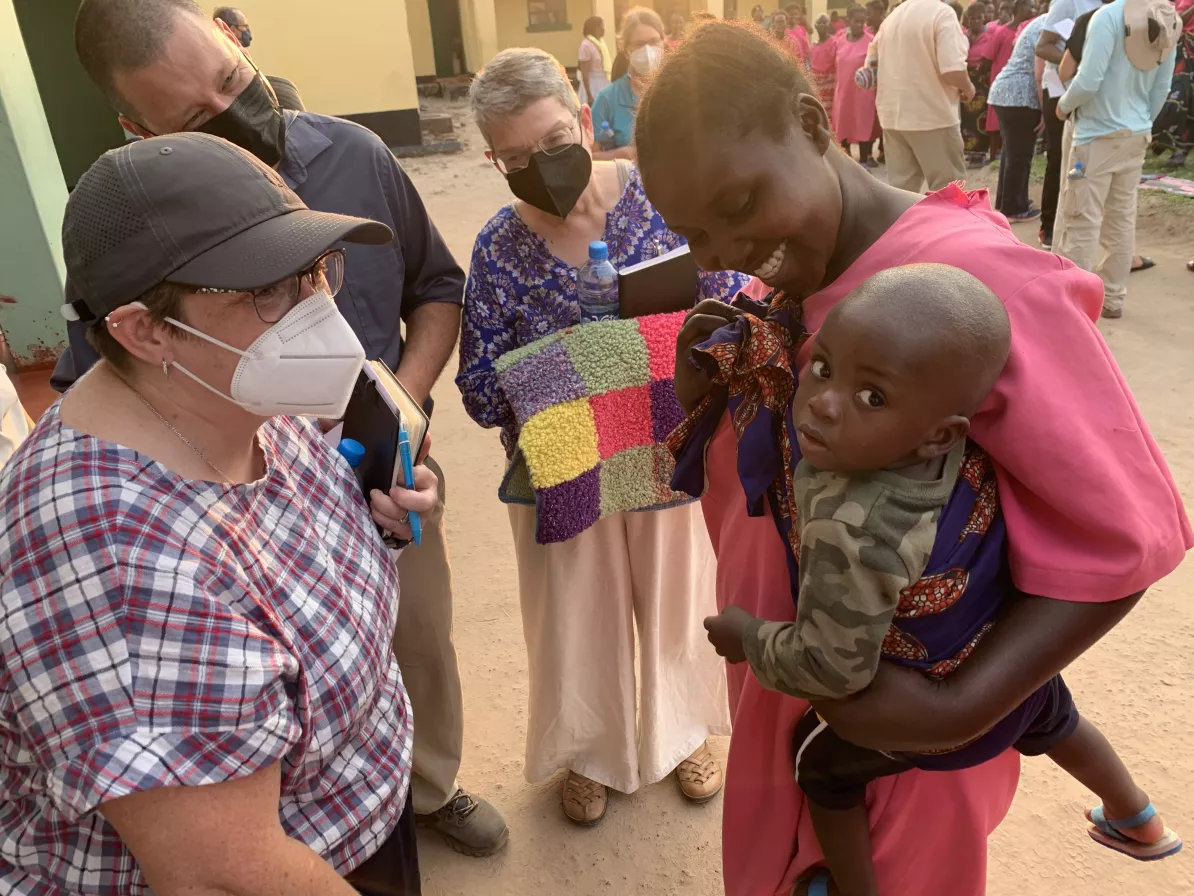 women with child interacting with other people