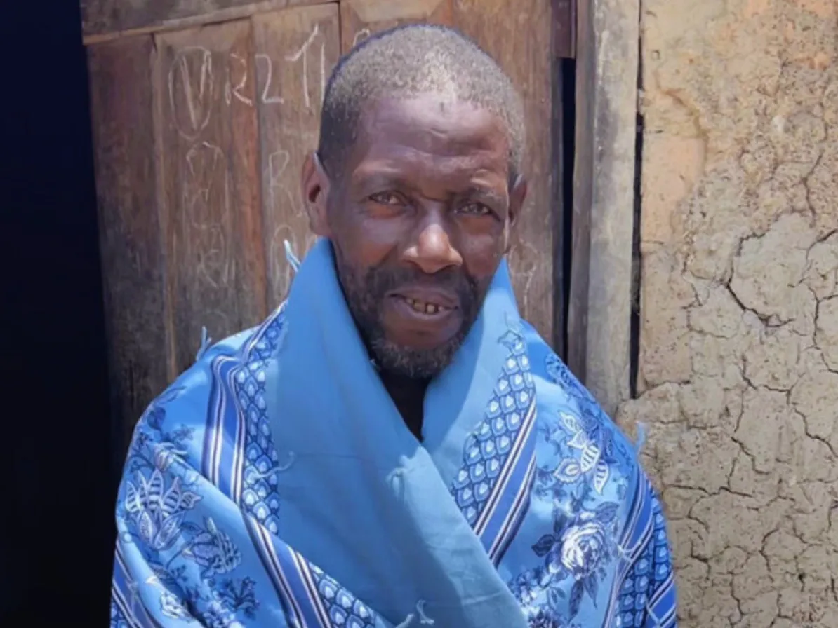 Man posing with comforter