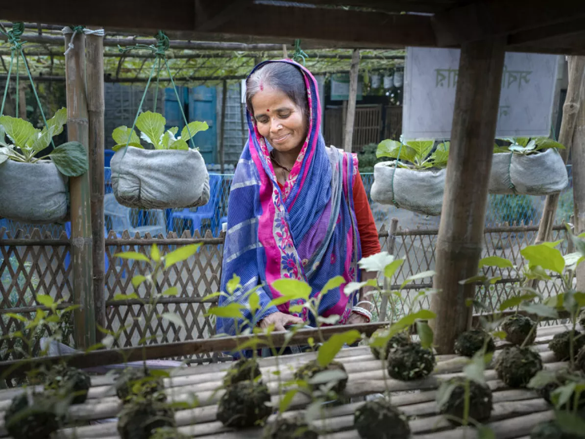 Ovagini Rani tends to the plants growing at her house. Growing seedlings to sell is one of many agricultural techniques she and her husband demonstrate at their “Smart House” so that neighbors can