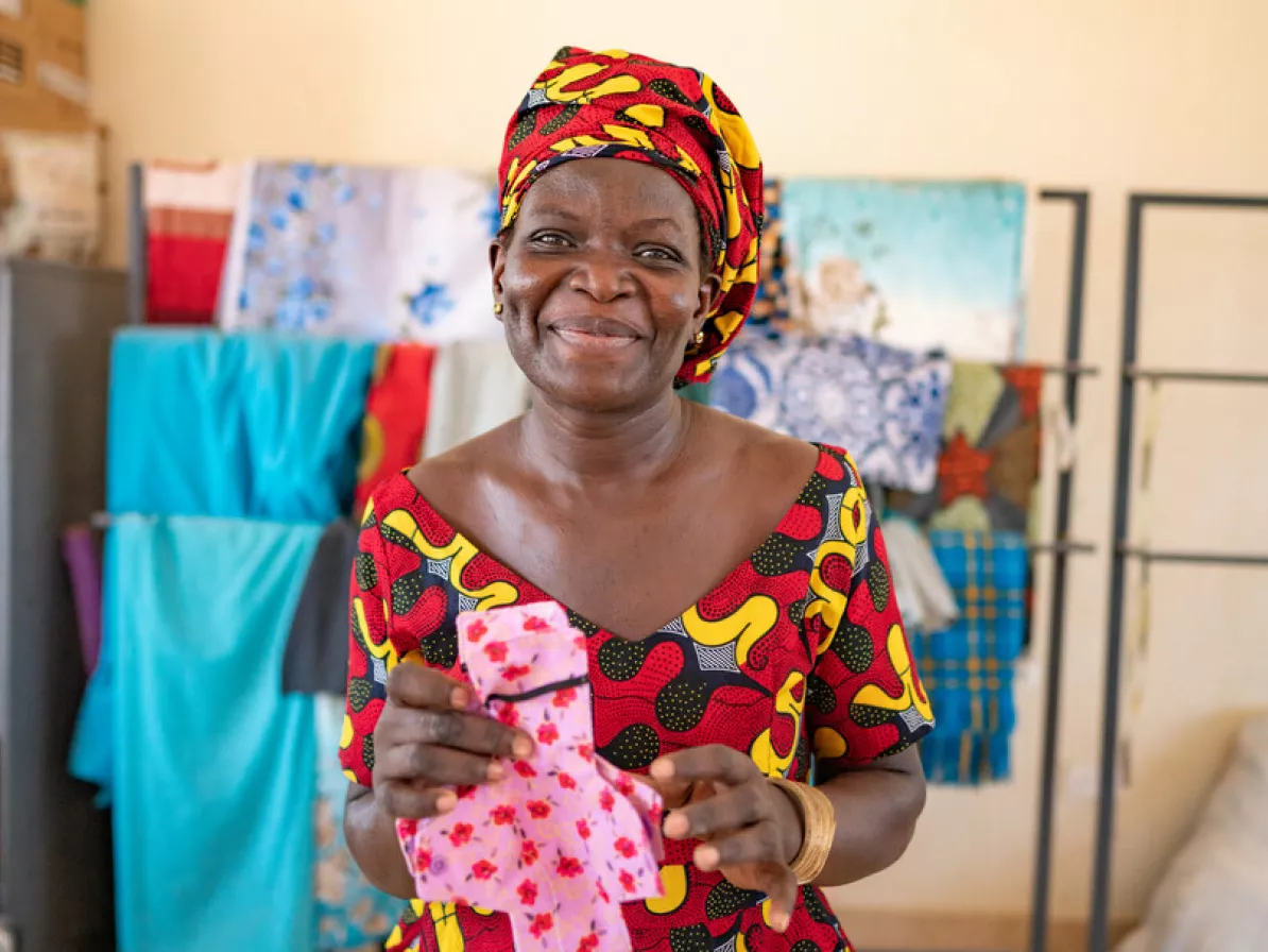 Millicent Teresa Otieno, 42, Loreto Rumbek School sewing instructor, holds an example of the reusable menstrual pad finished by the school dignity kit sewing project.