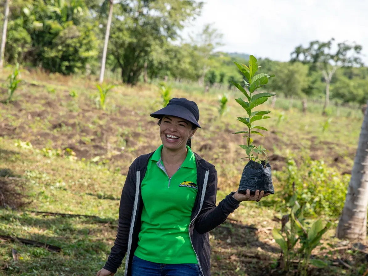 Etel Salas of MCC partner Sembrandopaz poses with a guava seedling.