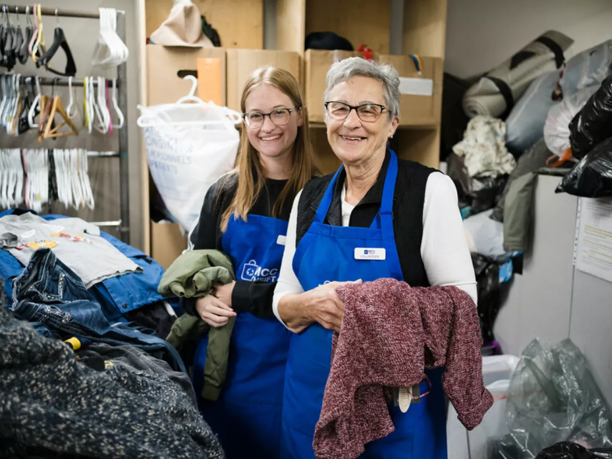 Amy Peters (left) and Darlene Rempel (Right) take a short break sorting through clothing donations at the Taber MCC Thrift Shop to pose for the camera.