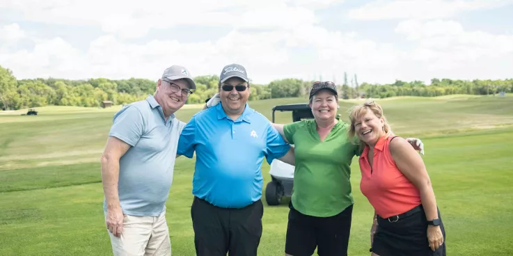 four people on golf green