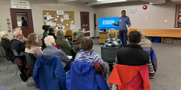 A man delivers a seminar to a small group of people