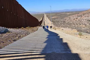 people walking up a slope 