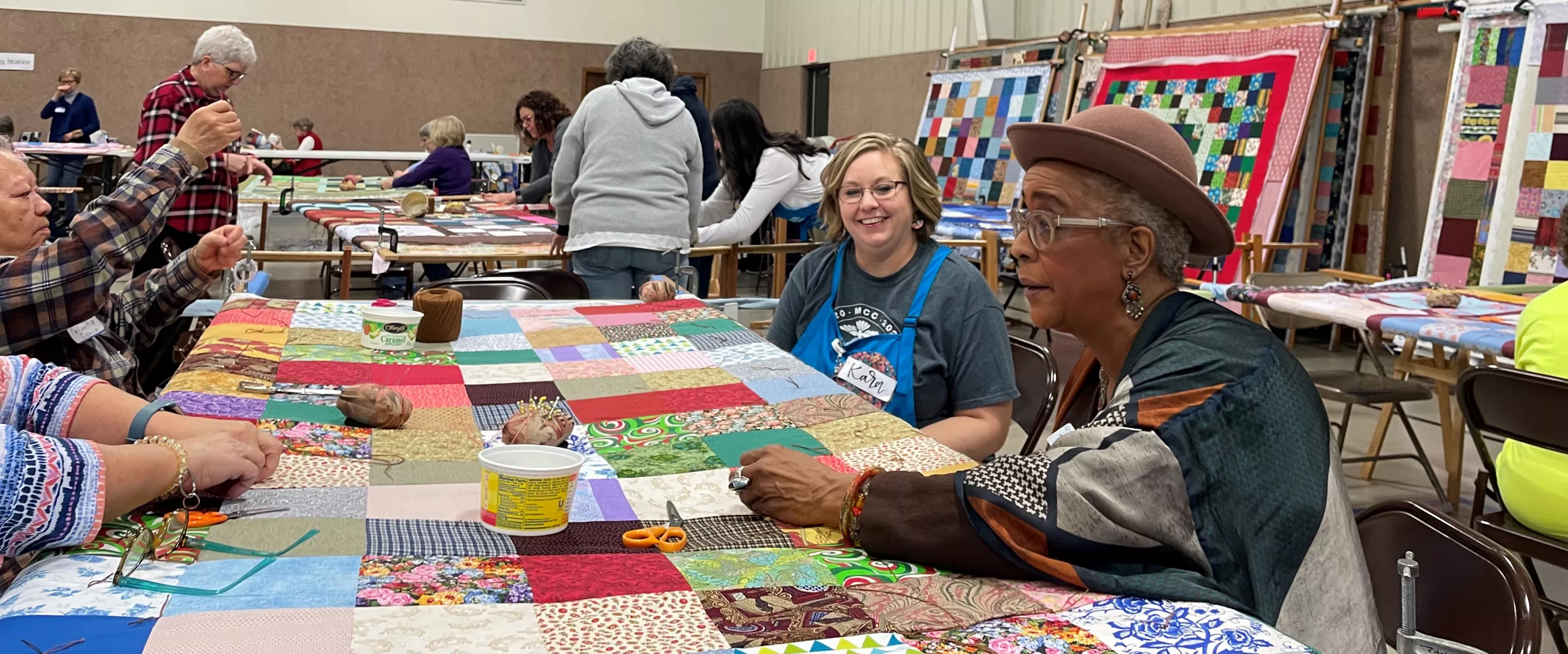 volunteers tie knots in comforters