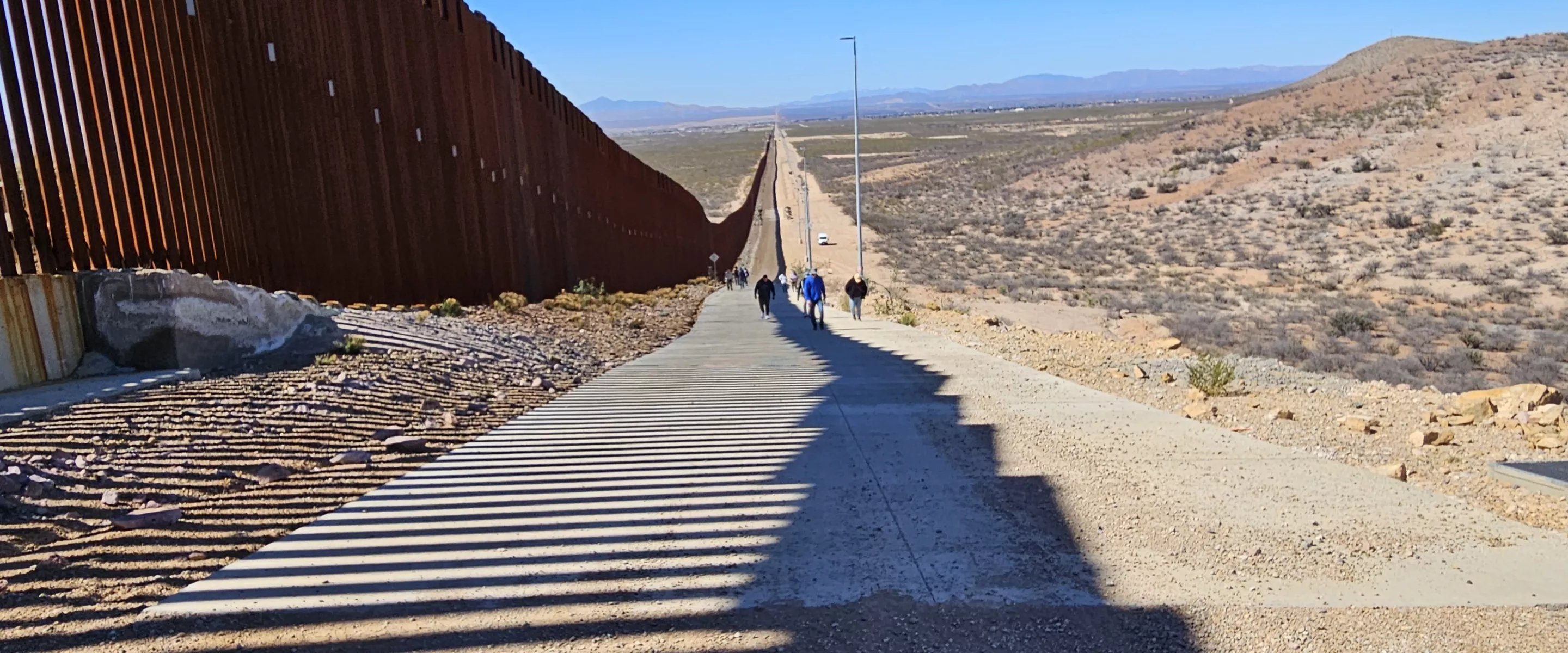 people walking up a slope 