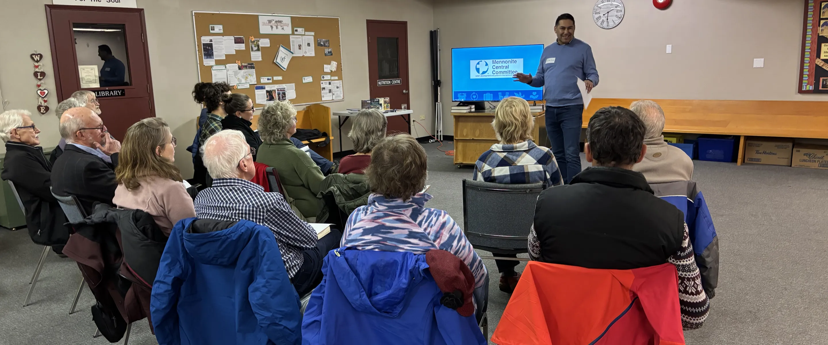 A man delivers a seminar to a small group of people