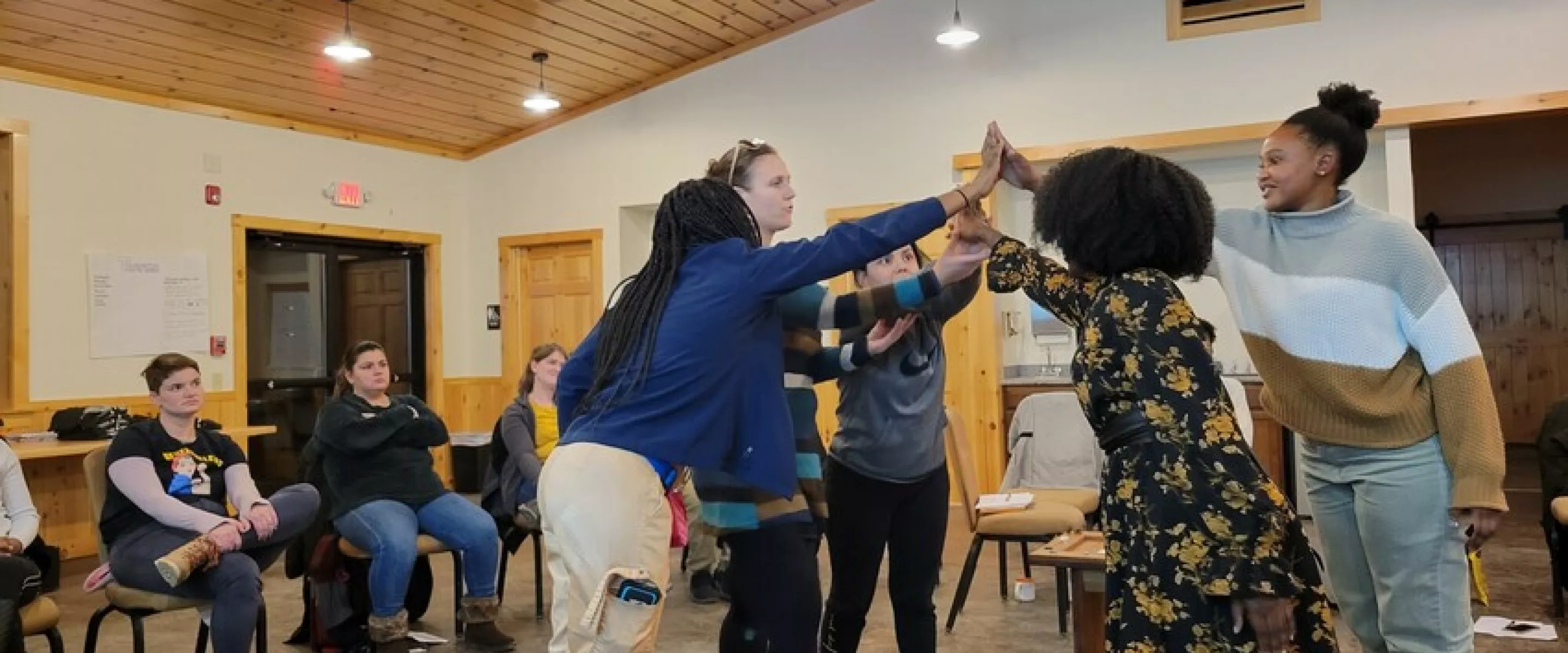 Participants in the week-long "Peace for the weary" camp for young adults held at Camp Deerpark in January build a symbol of reconciliation representing truth, mercy, peace and justice. Pictured from