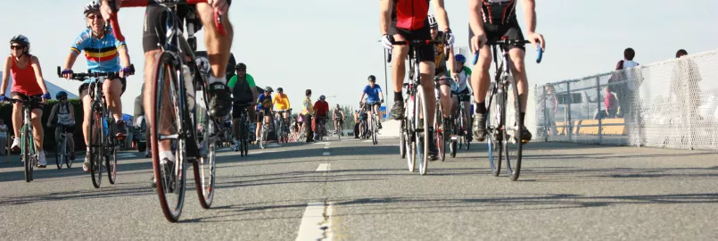 A group of cyclists bicycling toward the camera lens.