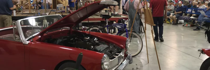 Vintage cars in front of auction stage