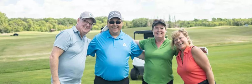 four people on golf green