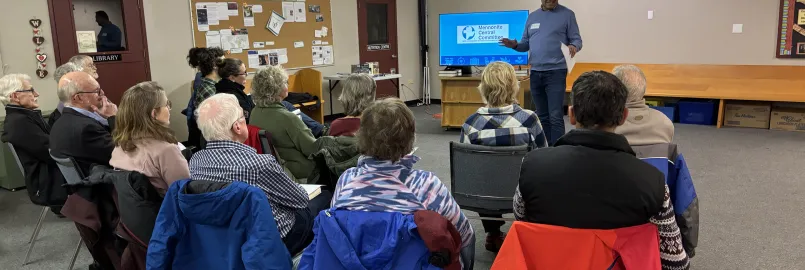 A man delivers a seminar to a small group of people