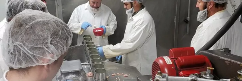 Caption: Volunteers in Newton, Kansas, put a teaspoon of salt in the cans before filling them with ground chicken. MCC photo/Josh Voth


More information: Volunteer groups representing Amish, Beach