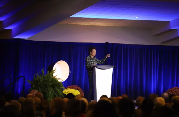 Malcom Gladwell speaking at a podium