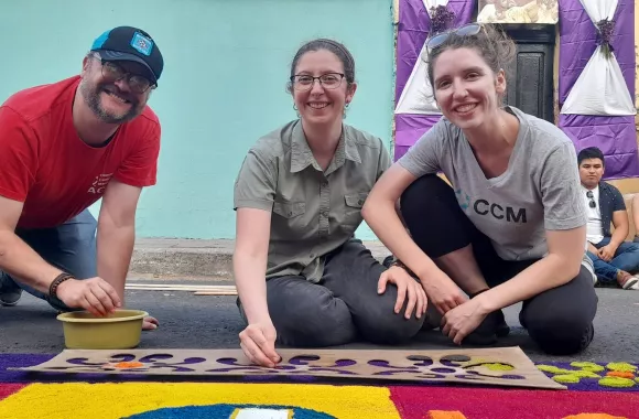 Three people smiling for a photo