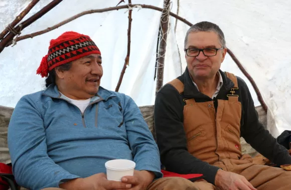 Rick Cober Bauman, MCC Canada Executive Director, and Jack Penashue sit together in Sheshatshit in Labrador during a visit in December 2018