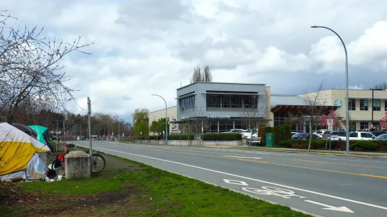 The exterior of MCC BC's office in Abbotsford near a road with many tents pitched to the side