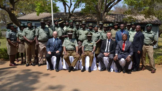 A group of Zambian correctional officers pose for a photo with visitors from Canada.