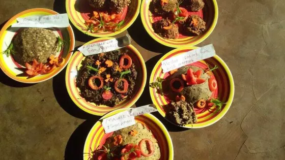 A group of six plates filled with a variety of food
