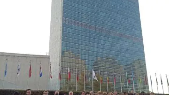 Group of forty-three students who participated in the UN Student Seminar stand in front of the United Nations building in New York City.