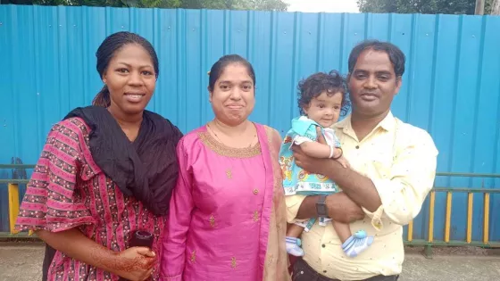 Two women, a man and child stand for a photo