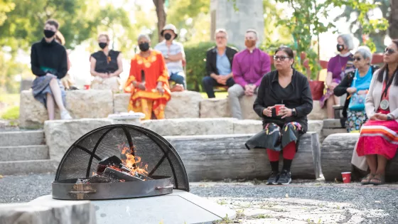 people gathering around a fire