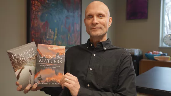 Man holding two books