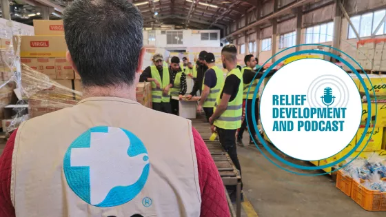 An MCC staff member observes workers packing emergency food packages in Amman, Jordan.