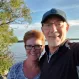 A man and woman smiling taking a selfie style photo